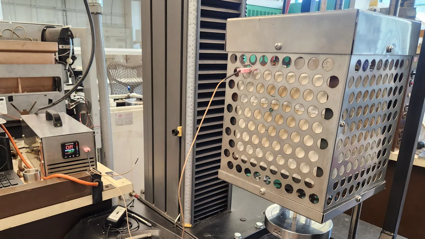 Real rapid-heating furnace assembly mounted in an Instron mechanical testing frame.