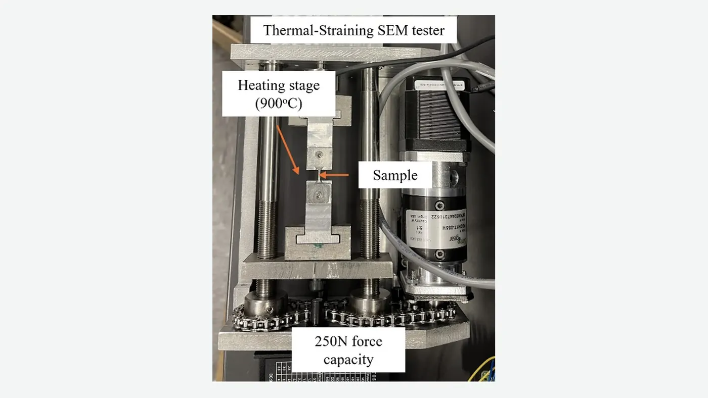 Real thermal-straining SEM tester with heating stage, sample position, and force-capacity label.